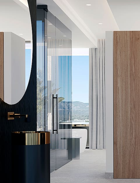 A modern bathroom featuring a round mirror, black vanity, and floor-to-ceiling wood cabinetry next to a glass-enclosed shower.