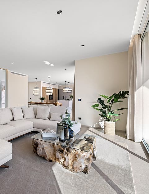 Open-plan living room opening directly to the pool terrace via retractable glazing