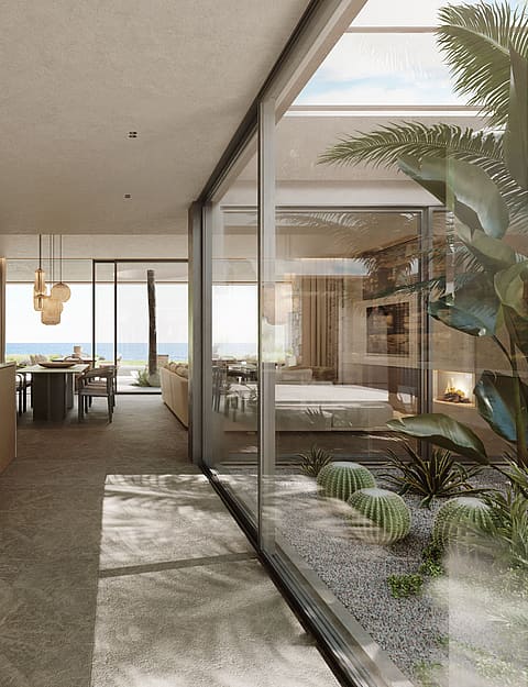 Modern open-plan kitchen featuring a white marble island, light wood cabinetry, and a glass-enclosed interior courtyard.