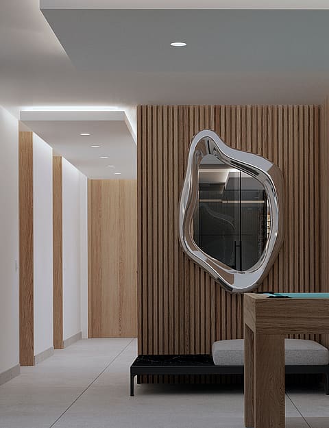Modern game room featuring a vertical wood-slatted accent wall, an irregular organic-shaped mirror, and a built-in wine display.