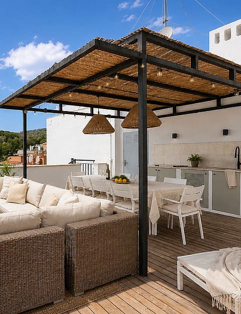 A spacious rooftop terrace in San Agustin with a wicker sofa set, a dining table under a thatched pergola, and a built-in outdoor kitchen.