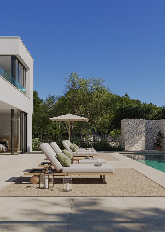 Wide angle view of a sun-drenched outdoor terrace with lounge chairs, a rectangular swimming pool, and stone wall features.