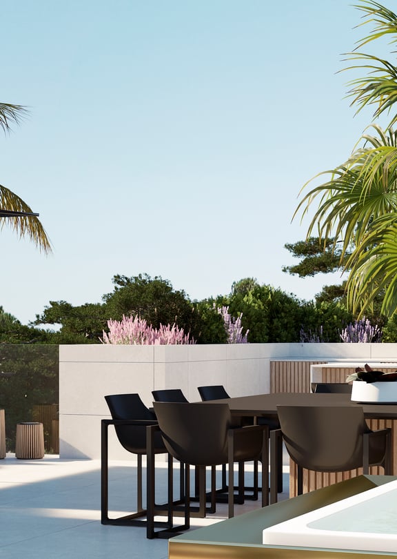 A rooftop terrace featuring a dark dining table and chairs, adjacent to a small pool, surrounded by palm trees and greenery.