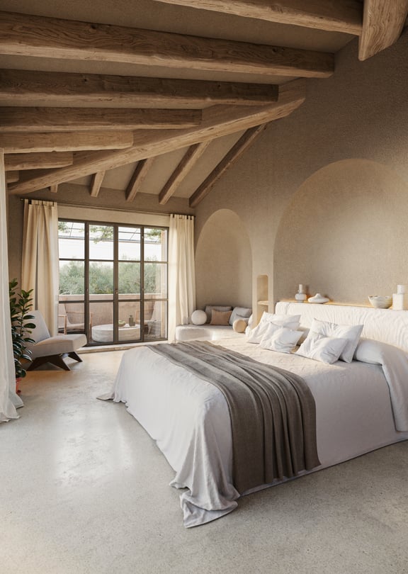 Spacious bedroom with stone walls, wooden vaulted ceiling, and large metal-framed glass doors opening to a terrace.