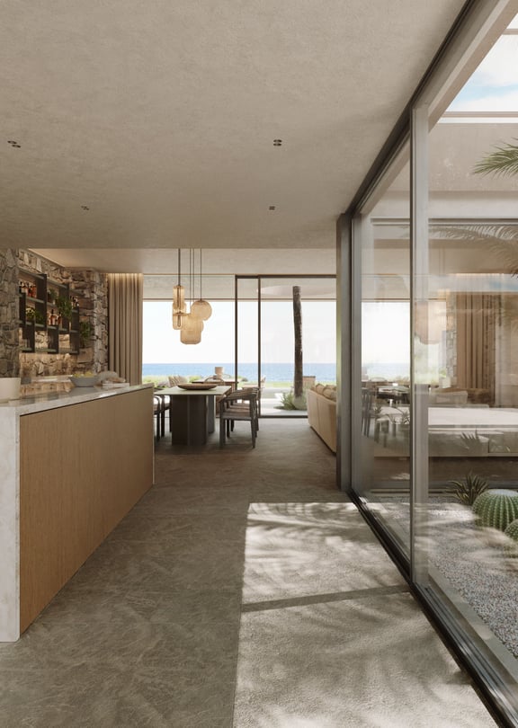 Modern open-plan kitchen featuring a white marble island, light wood cabinetry, and a glass-enclosed interior courtyard.