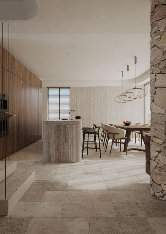 Contemporary kitchen featuring a fluted stone island, wooden cabinetry, and stone tiled flooring under warm recessed lighting.
