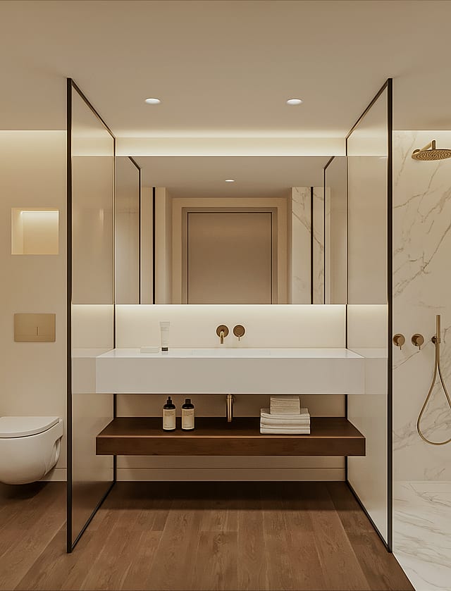 Marble en-suite bathroom with walk-in shower, brushed brass fixtures, wall-hung WC, floating basin on a timber shelf and a backlit mirror.