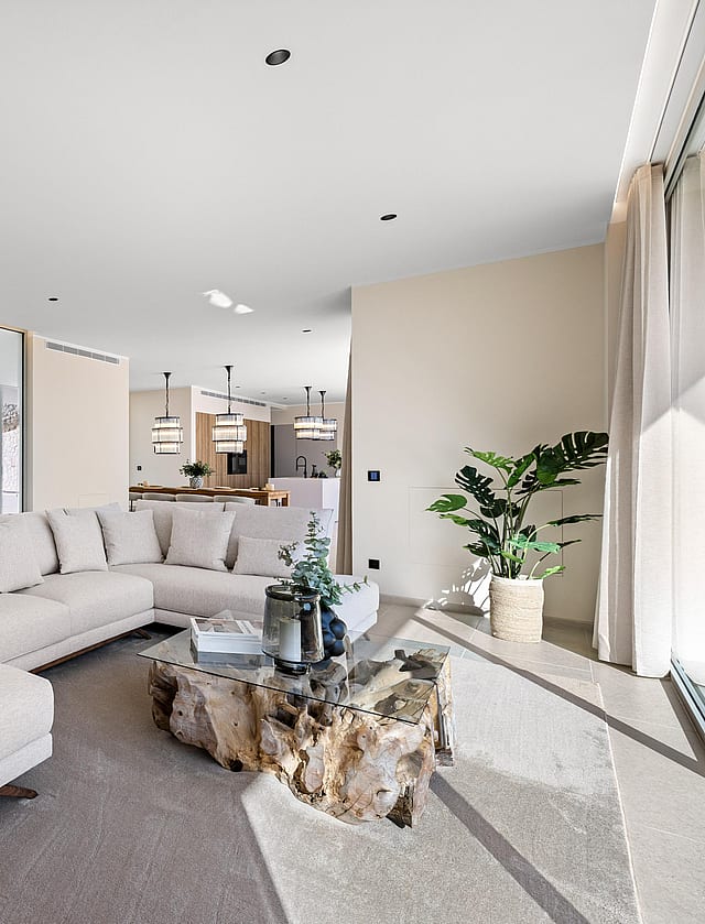 Open-plan living room opening directly to the pool terrace via retractable glazing