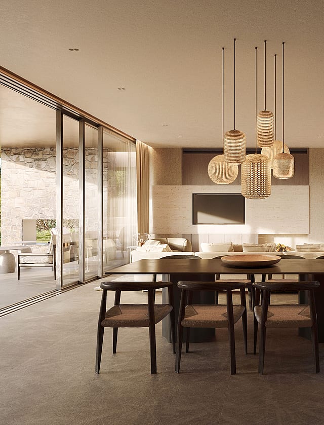 Dining room with long dark wooden table and woven chairs, glass walls opening to a lush garden, and a modern tiered chandelier.