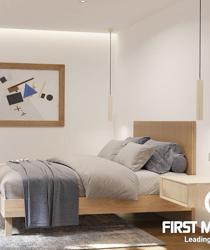 Modern bedroom featuring a wooden bed frame, slatted headboard, plush grey rug, and minimalist lighting against white walls.