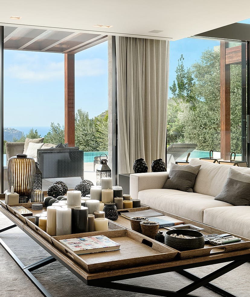 Open-plan living and dining room with natural-toned furnishings and large glazing