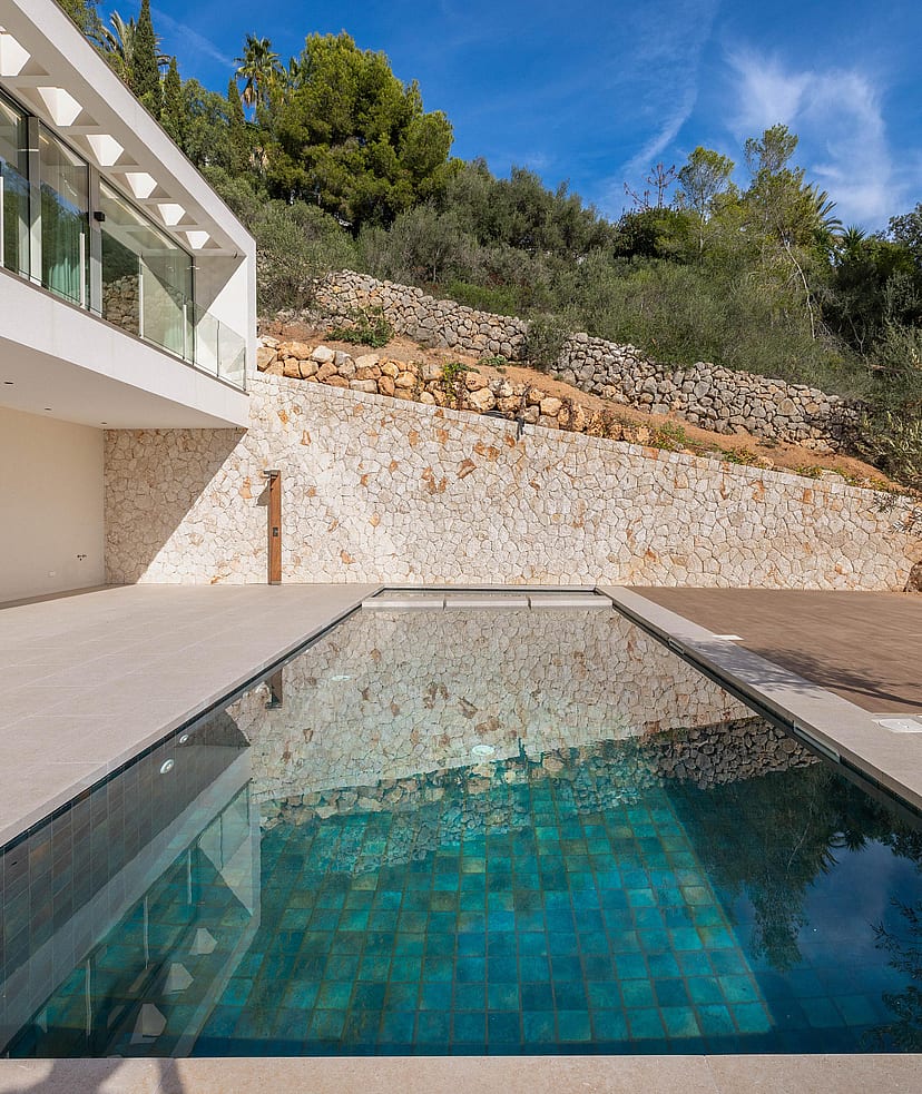 Two-storey contemporary villa with full-width floor-to-ceiling glass overlooking terraced gardens