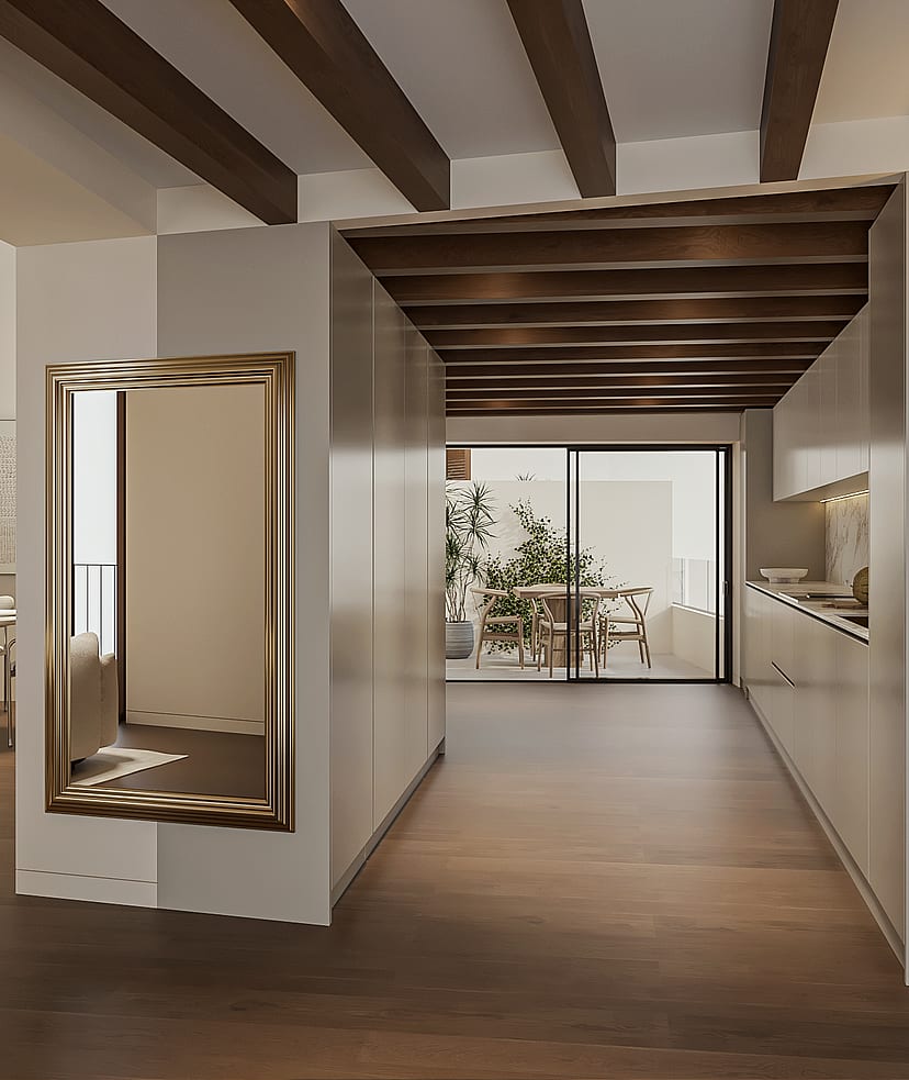 Open-plan kitchen with pale bespoke cabinetry and marble splashback beside a dining table, glazed doors to an interior terrace, exposed timber beams overhead.