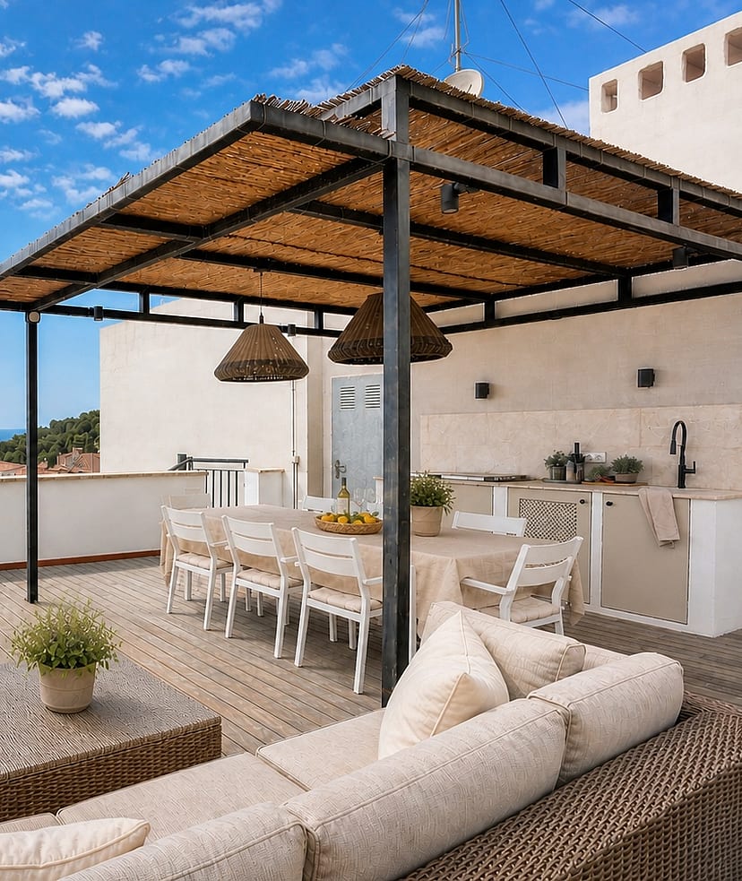 A spacious terrace in San Agustin with a shaded dining area, woven rattan sofa, and a stone-built outdoor kitchen.