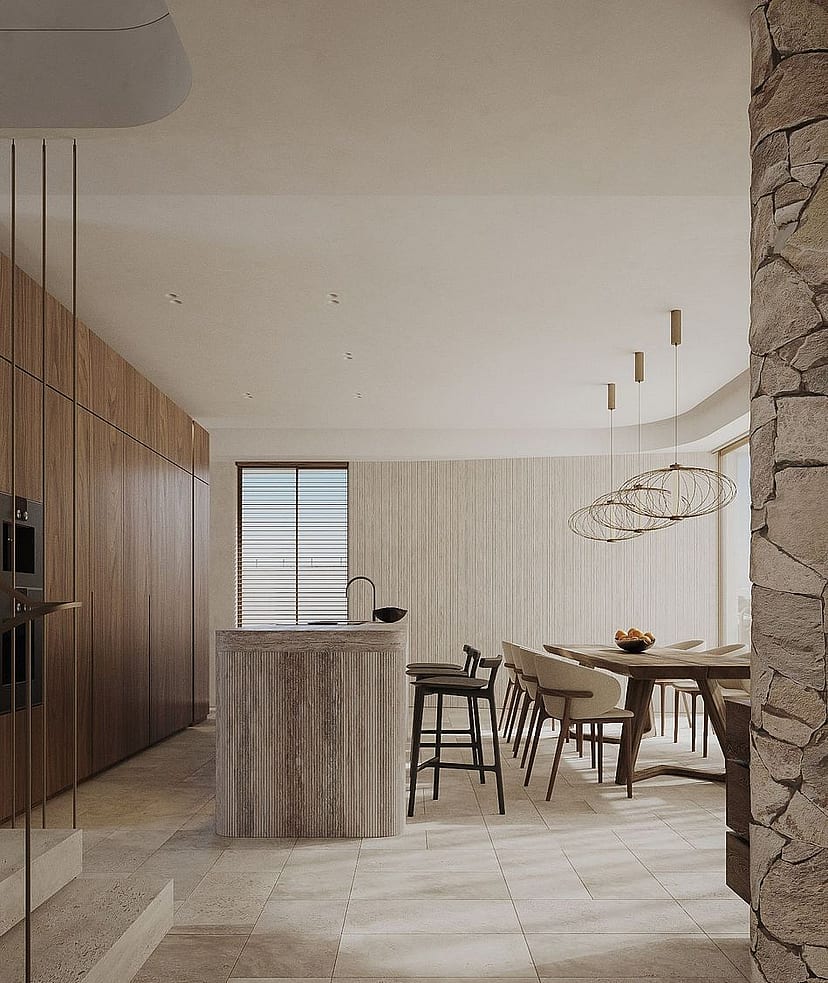 Contemporary kitchen featuring a fluted stone island, wooden cabinetry, and stone tiled flooring under warm recessed lighting.