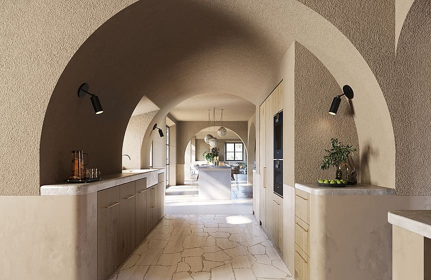 Interior view of a kitchen featuring a large stone vaulted ceiling, textured plaster walls, and light-toned cabinetry.