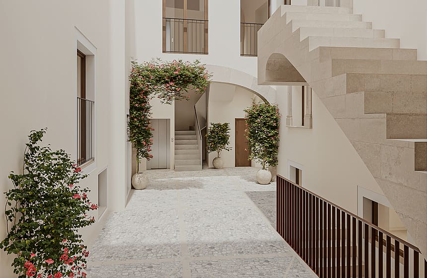 Interior courtyard featuring Marés stone, stone stairs, and greenery within a restored historic building.