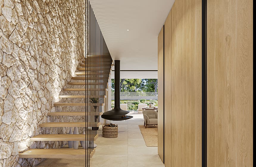 A wide entrance hall featuring a rough-hewn stone wall, wooden floating staircase with black railings, and tall oak cabinetry.