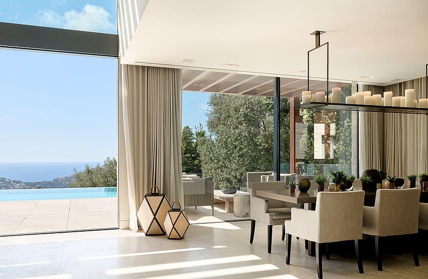 Open-plan living and dining room with natural-toned furnishings and large glazing