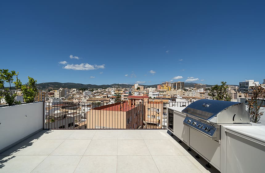 Private rooftop terrace featuring a stainless steel grill, overlooking the cityscape of Santa Catalina.