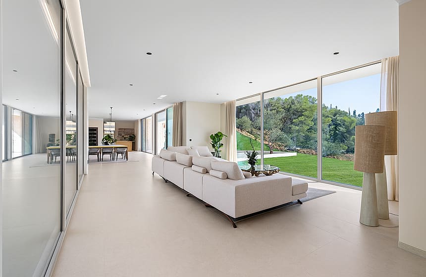 Spacious living area with oversized sectional sofa and full-height sliding glass to pool terrace