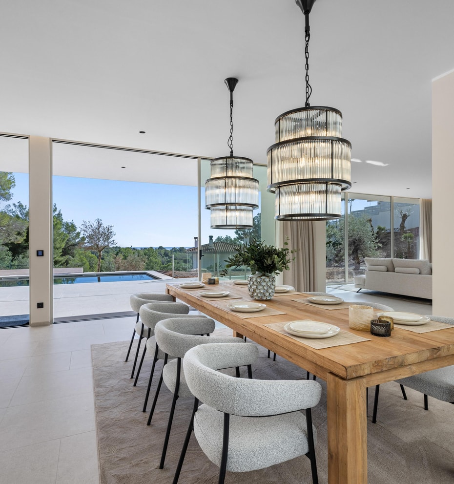 Dining room with statement pendants and retractable glass wall to the pool terrace