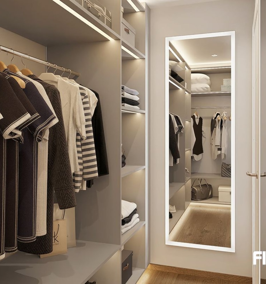 A modern walk-in wardrobe featuring hanging rails, open shelving, and a full-length mirror with LED perimeter lighting.